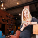 Receptionist of beauty salon with smartphone