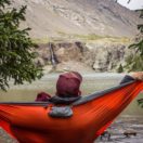 Man relaxing in a hammock while camping; work life balance concept