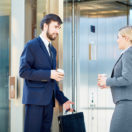 Business man and woman waiting for an elevator; elevator speech concept
