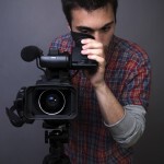 Young Man Filming With Video Camera - Square