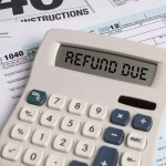 Taxes - 1040 forms and Refund Due on Calculator Square