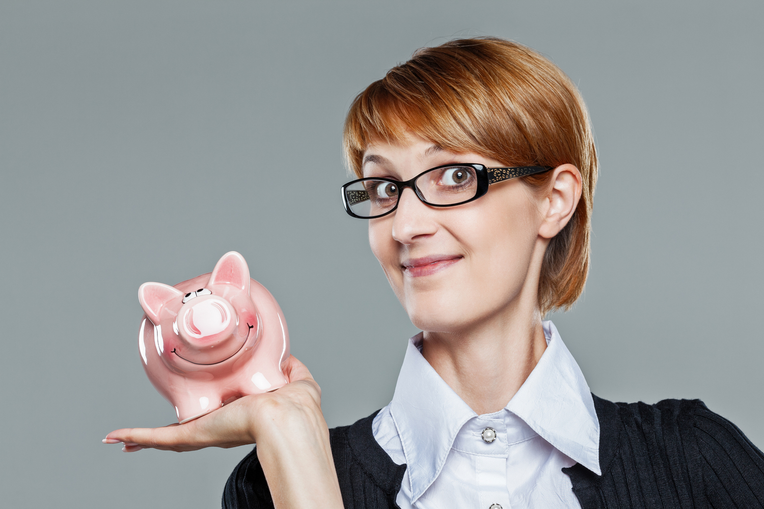 Businesswoman holds piggybank