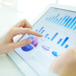 Woman Analyzing Metrics on Tablet