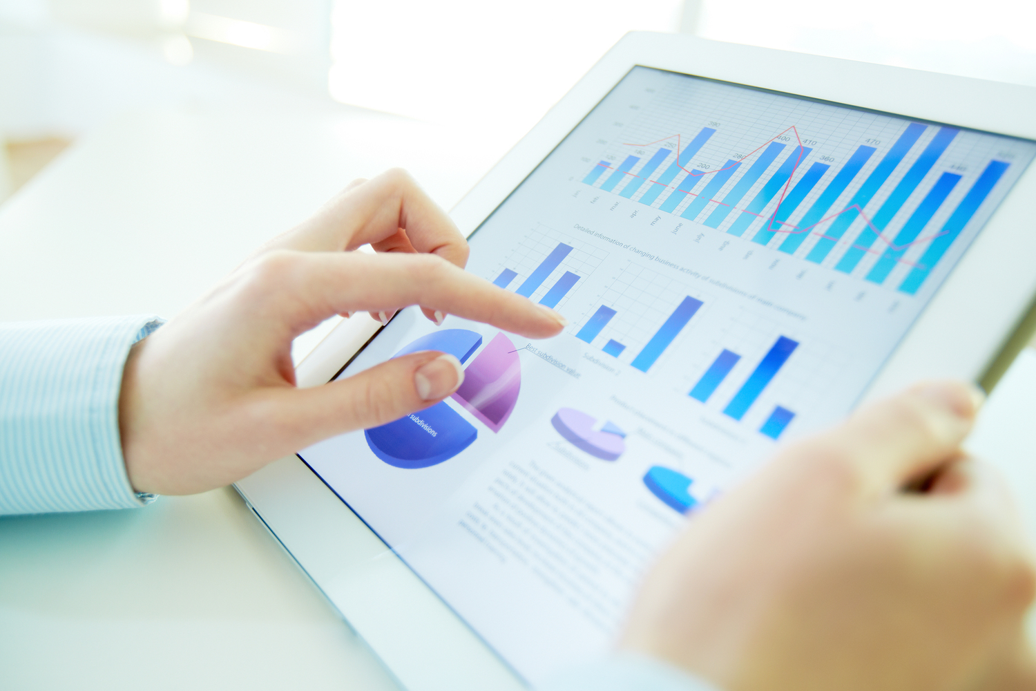 Woman Analyzing Metrics on Tablet
