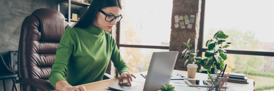 6 Cloud Accounting Benefits for Small Businesses Explained 1 Female entrepreneur working in her home office on cloud accounting software and exploring her financials.