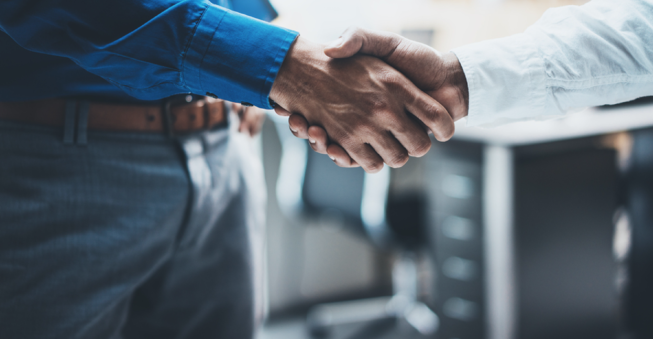 Businessmen shaking hands after business deal