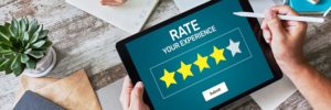 image of a customer using her iPad to rate a business out of the five star scale