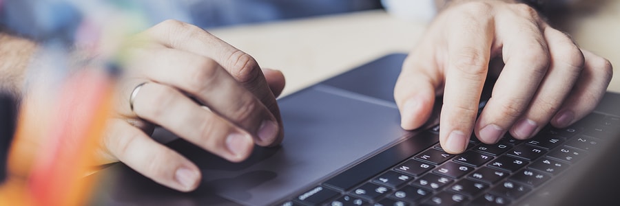 close up of employee filtering through emails on computer