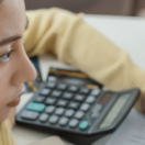 Female entrepreneur working on her financial statements, worried about funding