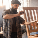 young solopreneur working on woodworking project for his small business.