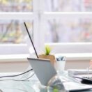 entrepreneur working on laptop in office thinking through the need to write a business plan